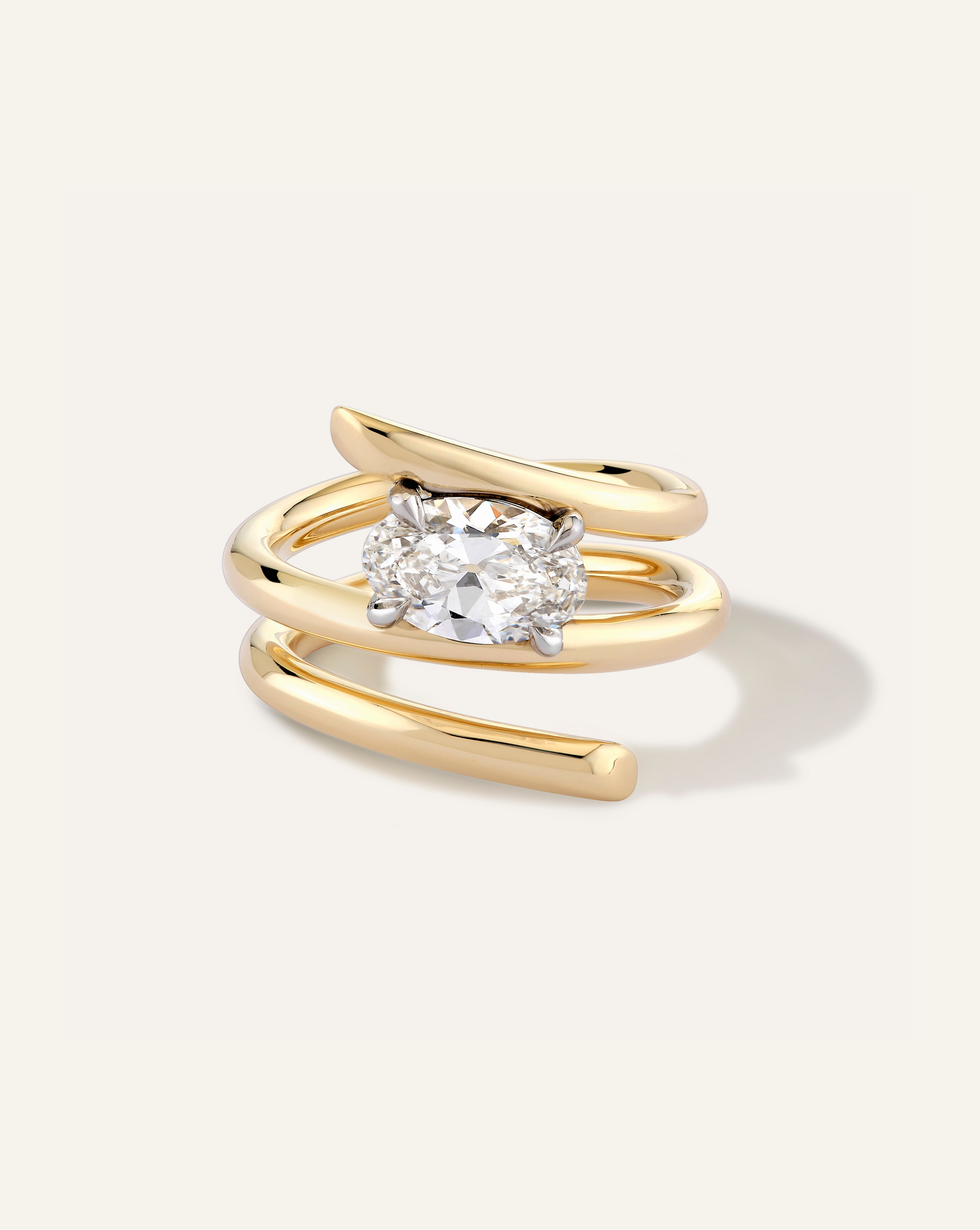 Gold ring with a diamond on a white background